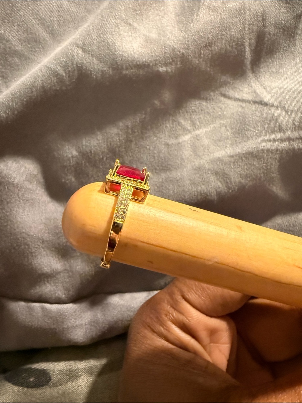 Elegant Gold Ring with Red Gemstone and Pavé Accents